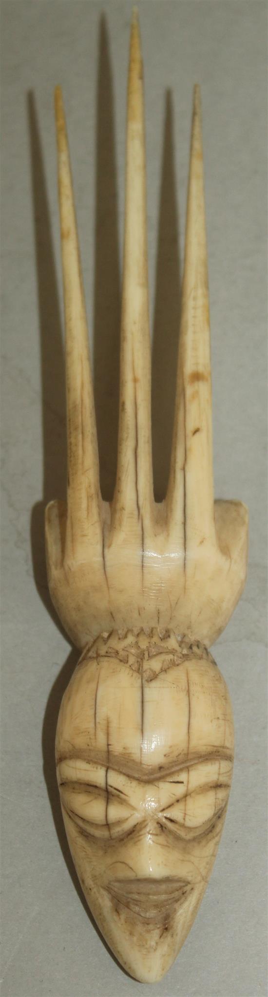 A 19th century Pende? ivory comb, 5.75in.